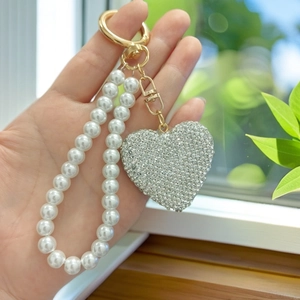 Sparkling heart keychain with rhinestones and pearl bead strap on a golden clasp