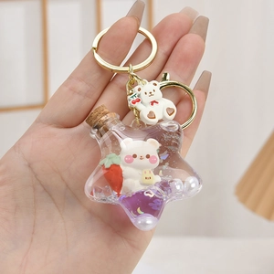 Cute star-shaped quicksand keychain with purple bear charms and golden keyring