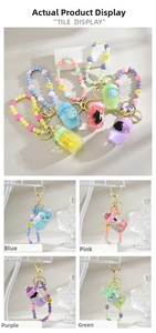 Detail of colorful liquid oil quicksand bottle charms with cute beads for bags and keys