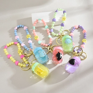 Five colorful cartoon milk bottle liquid quicksand keychains with floating animals and beads