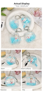 Detail of blue liquid acrylic keychains featuring cute bunny figures and sparkling sequins