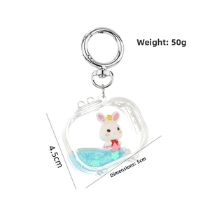 Detail view of acrylic TV-shaped keychain with blue liquid glitter and mini rabbit toy