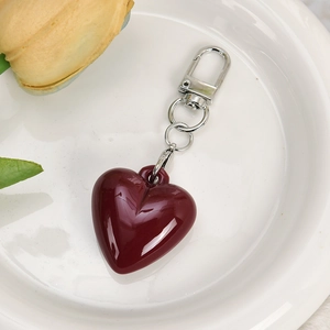 Close-up of deep red heart keychain with mirror finish and silver lobster clasp