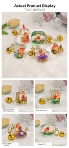 Detail of Capybara liquid acrylic keychains in heart and bottle shapes with gold charms