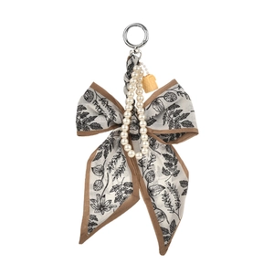 Charm de sac nœud à imprimé floral avec chaîne perlée et clip métal sur blanc