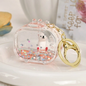 Detail of a clear acrylic capsule keychain with a white bear and red floating glitter