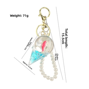 Detail of ice cream keychain with dolphin inside, showing 15.5cm length and pearl chain