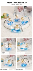 Detail of acrylic liquid quicksand keychains with blue oil, sequins and miniature models
