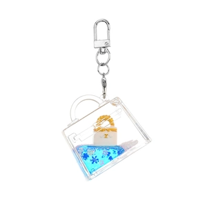 Acrylic quicksand keychain with blue liquid and miniature handbag inside a bottle