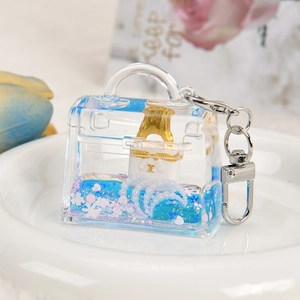 Acrylic quicksand keychain in handbag shape with blue liquid and silver clasp