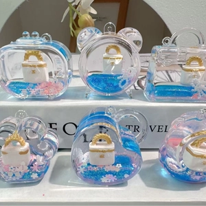 Acrylic drifting bottle keychain with blue liquid and mini luxury handbag inside