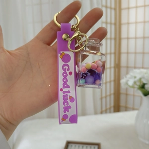 Details zum violetten Bär-Schlüsselanhänger mit flüssigem Treibsand und Handschlaufe
