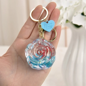 Rose shaped liquid quicksand acrylic keychain with red and blue resin stone glitter effect