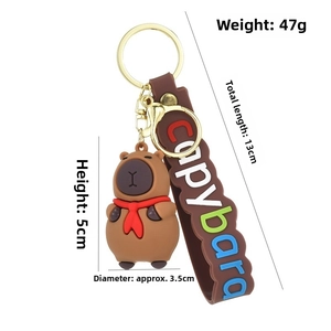 Macro shot of a 5cm Capybara keychain with red scarf and detailed dimensions markings