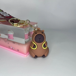 Close-up of cute brown Capybara keychain with yellow swim ring and Capy charm strap