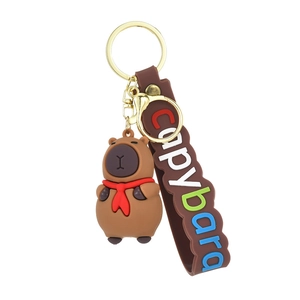 Cute brown Capybara keychain with red scarf and colorful wrist strap on white background