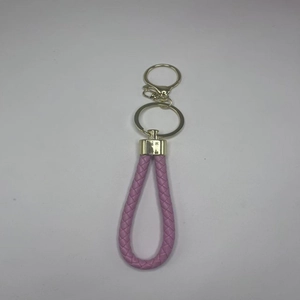 Detailansicht eines rosa geflochtenen Leder-Schlüsselanhängers mit goldenem Clip