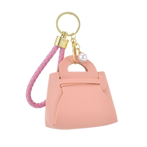 Mini rosa Kunstleder Münzbörse Schlüsselanhänger mit geflochtenem Band und Perle auf weißem Grund