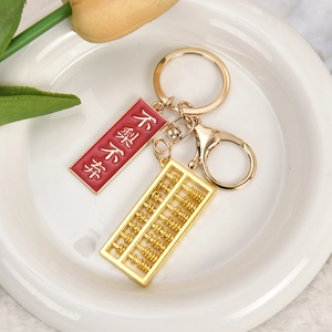 Golden metal abacus keychain with red enamel charm and lobster clasp accessory