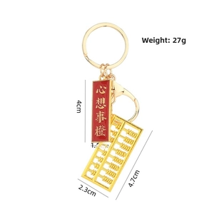 Detailed view of golden abacus keychain with dimensions 4.7x2.3cm and 27g weight