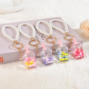 Set of four cute acrylic milk tea cup keychains with pearl wristlets and colorful liquid