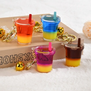 Creative liquid quicksand milk tea cup keychains with golden bells in four vibrant colors