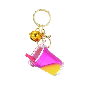 Creative milk tea acrylic keychain with flowing pink liquid and golden bell accessory