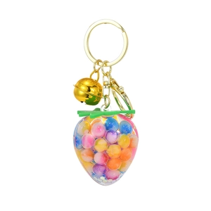 Colorful strawberry resin keychain with gradient beads inside and golden bell charm