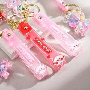 Detailed close-up of Fruit Bears silicone wrist strap and cute bear keychain charm