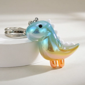 Macro detail of acrylic dinosaur keychain with pearlescent gradient and silver metal clip