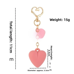 Pink heart keychain featuring a gold clasp and For Ever engraving with dimensions detail