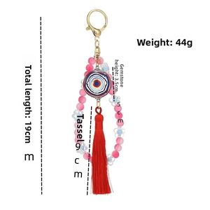 Detail view of handmade beaded keychain with blue evil eye charm and red tassel measurements