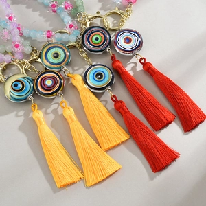 Close-up of handmade evil eye beaded keychain with colorful floral beads and silk tassels