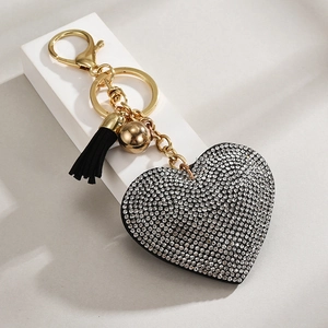 Close-up of sparkling heart keychain with black tassel and gold lobster clasp detail