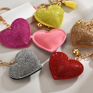 Detail of heart-shaped keychains with rhinestones and colorful tassels in various colors