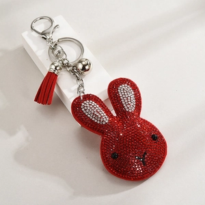 Detail of red rhinestone bunny keychain with leather tassel and silver hardware