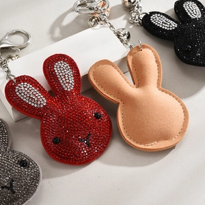 Detail showing crystal rhinestone bunny keychain with metallic clasp and soft texture