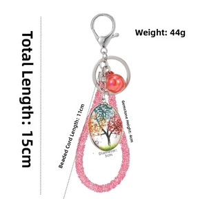 Macro detail of Tree of Life glass pendant and pink beaded keychain with dimensions