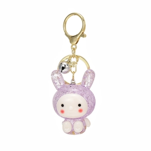 Cute purple glitter bunny keychain with a golden clasp and silver bell on white background