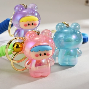 Detailed view of translucent resin bear keychains in pink, blue, and purple pearlescent
