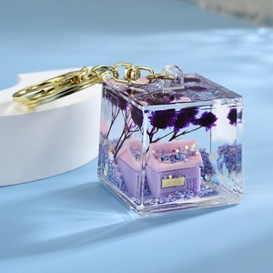 Purple quicksand cube resin keychain with lavender miniature model and gold metal ring