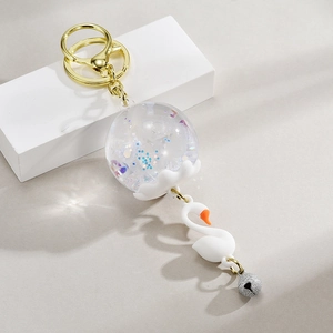 Porte-clés carillon cygne créatif avec anneau doré et paillettes colorées à l'huile