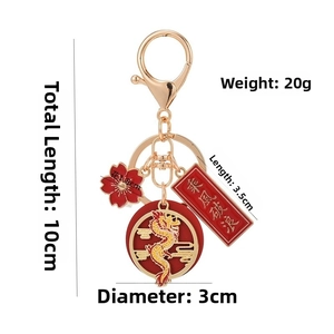 Detailed view of Year of the Dragon keychain with dimensions and red tassels