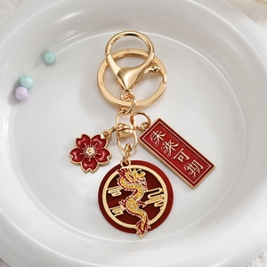 Macro view of Chinese New Year dragon keychain with flower charm and blessing tag