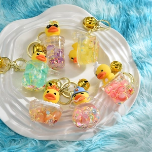 Cartoon rubber duck liquid keychain featuring colorful flowing beads and a golden ring