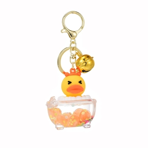 Cartoon yellow duck keychain in mini bathtub with star sequins and golden bell