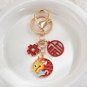 Detail of Year of the Dragon keychain with colorful enamel dragon and fortune pendant