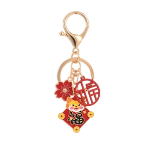 Golden Chinese zodiac dragon keychain with festive red plum blossom and fortune charms