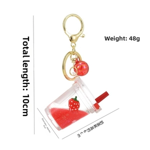 Detail of creative strawberry acrylic keychain with liquid quicksand and floating strawberry