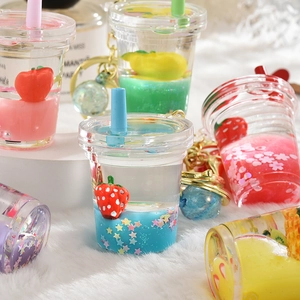 Detail of colorful acrylic liquid fruit keychains featuring glitters and floating charms